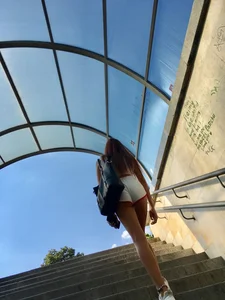 Cute candid girl with glasses in white shorts showing cheeks
