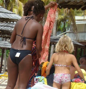 Sexy black babe in various bikinis on the beach while on vacation