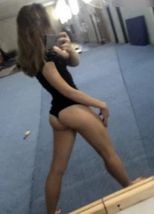 Young Skinny Girl in Tights Gymnasium Mirror Selfie