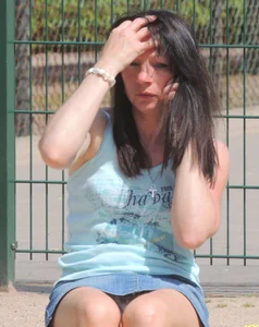 Brunette sitting upskirted showing her white lace panties