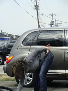 Girl cleaning her car in jeans and showing some cheetah print underwear