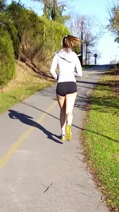 Athletic girl out for a run in short spandex shorts