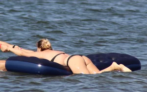 Black thong bikini blonde with a nice ass out on a tube in the water