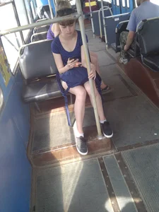 Cute teen in shorts sitting in a public bus