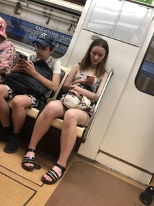 Candid girl in sandals subway train creepshot