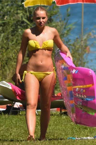 Blonde looking sexy in a yellow bikin