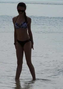 Two candid skinny teen sisters in bikinis