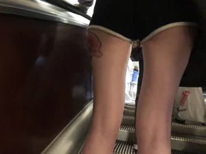 A Tall And Slim Candid Girl in Spandex Shorts in a Hoodie Top, With Tattoos on Her Long Legs Subway Creepshots