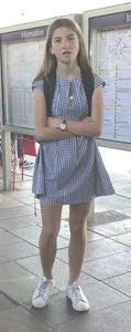Cute girl wearing a dress at the train station