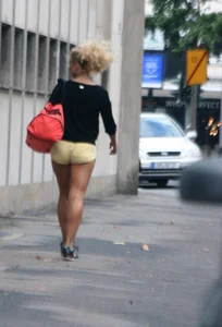 Blonde looking sexy walking in short yellow shorts