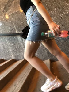 Hot chick wearing a fringed skirt walking up the stairs