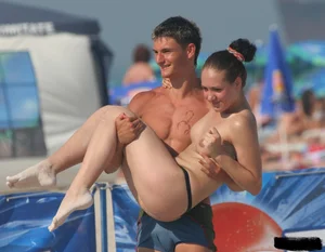 A bunch of sexy beach voyeur babes in bikinis, thongs and topless