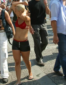 Sexy mature blonde in wet shorts and red bikini with thong sticking out