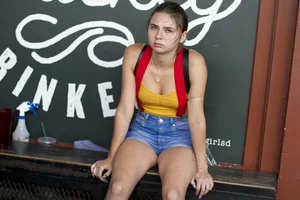 Sexy candid cutie wearing denim shorts sitting on a bench sulking, hot legs