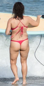 Thick brunette milf on the beach in red thong bikini