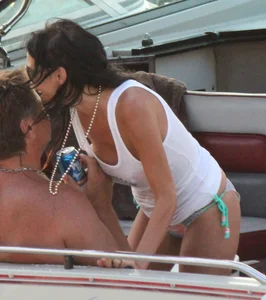 Bikini babe on a boat with a wet see through white shirt showing her tits