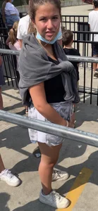 Teen with braces waiting in line for a ride
