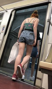 Two Girls With Hot Long Legs in Mini Shorts and Sneakers in the Subway Train Candid Photo Gallery