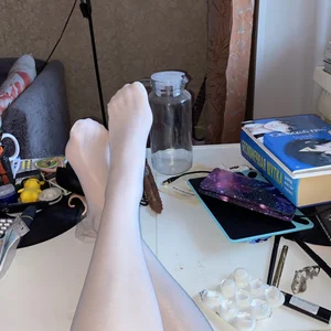 Skinny girl in white pantyhose home mirror selfies and closeup of her legs on table