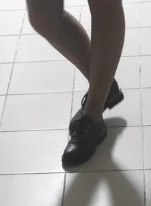 Slim Legs of a College Teen in a Skirt, Pantyhose And Shoes Standing in the Hallway Sneaky Photos