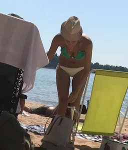 Swedish beach blonde girl in white and green bikini