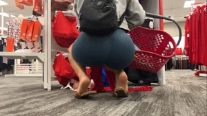 Latina squatting in spandex shorts