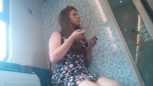 Cute girl in a short dress sitting with crossed legs