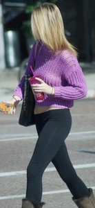 Beautiful skinny blonde in tight leggings and purple crop top showing sexy stomach
