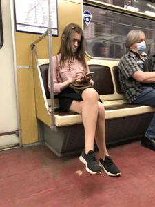 Cute masked candid girl sitting with crossed legs in a subway train creepshots
