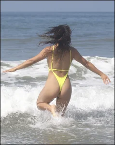 Sexy ass beach babe in a yellow thong swimsuit