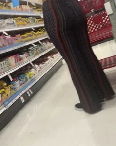 White girl in flare pants bending over