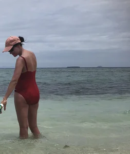 Milf at the beach in a red swimsuit with a nice body