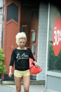 Blonde looking sexy walking in short yellow shorts