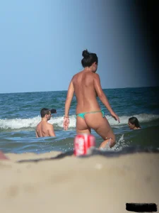 Bunch of sexy babes on the beach topless and in thong bikinis