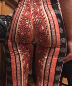 Big fat ass in pattern flare pants with some pokey pierced nipples in a blue crop top