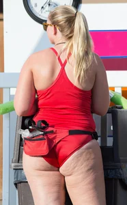 Thick blonde lifeguard in red swimsuit