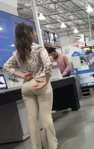 Plus Face shot - Gorgeous AT&T babe in beige pants  touching her ass with long red nails