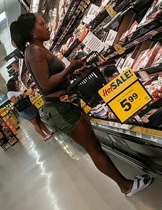 Ebony chick grocery shopping in green shorts