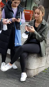 Cute candid street girl sitting with crossed legs