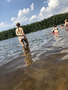 Cute Girl in Swimsuit Standing in Water and Lying on a Beach Gallery