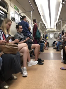 Candid subway hottie sitting in a train with crossed legs