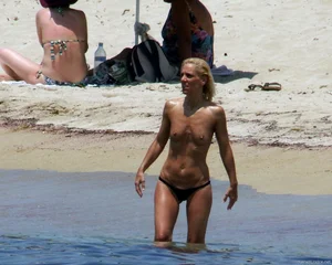Small boobed topless milf on the beach