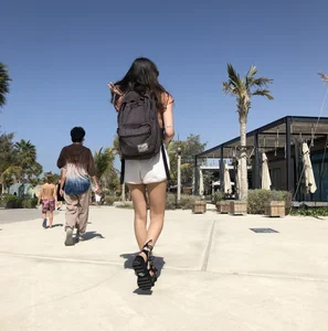 Candid hottie in shorts with a backpack