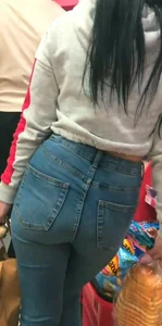 Skinny brunette with a nice booty in line in tight jeans