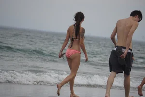 Peach bikini tattood babe on the beach with a nice ass and some camel toe