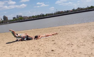 Girl laying out getting sun in a white thong bikini