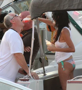Bikini babe on a boat with a wet see through white shirt showing her tits