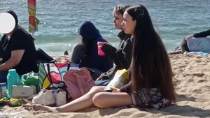 Beautiful Teen with Miniskirt resting on the beach