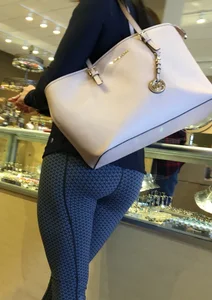 Brunette jewelry shopping in leggings with a nice ass