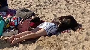 Beautiful Teen with Miniskirt resting on the beach